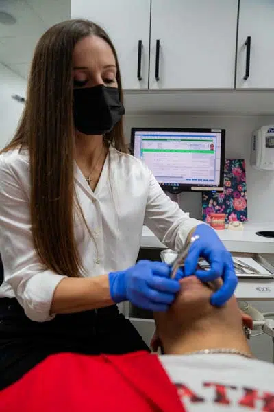 Dr. Freeman of North Texas Smiles providing orthodontic care for her patient