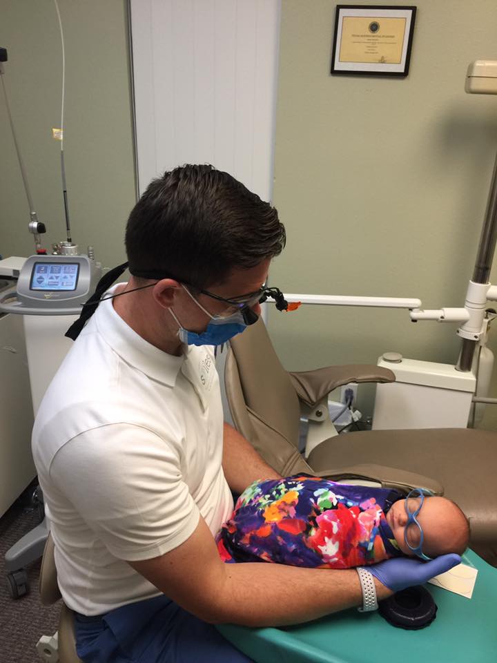 infant patient receiving a dental procedure quickly thanks to the latest dental technology