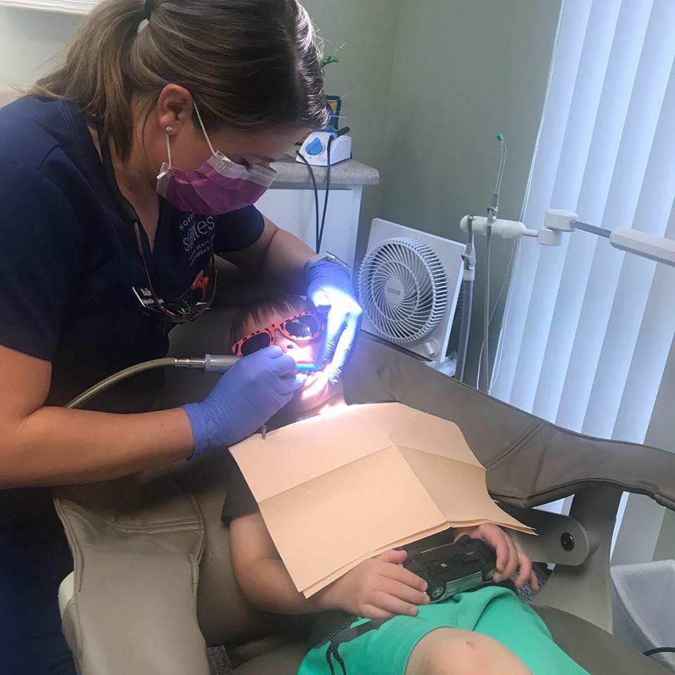 Young patient getting work done but taking advantage of sedation dentistry to be calm and relaxed during treatment at the Fort Worth, TX office.