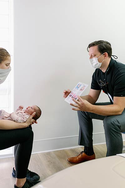 dentist discussing how lip and tongue tie releases work